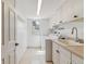Efficient laundry room with white cabinets, sink, and side by side washer and dryer at 6918 E Easter Pl, Centennial, CO 80112