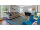 Cozy living room with a comfortable sofa, hardwood floors, and lots of natural light from large windows at 6918 E Easter Pl, Centennial, CO 80112