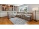 Cozy living room features a bay window, fireplace, hardwood floors and neutral paint at 6918 E Easter Pl, Centennial, CO 80112
