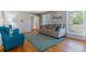 Bright and airy living room featuring a comfortable sofa, colorful accents, and gleaming hardwood floors at 6918 E Easter Pl, Centennial, CO 80112