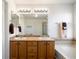 Bathroom features double sink vanity with granite countertop and decorative tile backsplash at 2085 Cactus Bloom Ct, Castle Rock, CO 80109