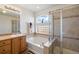 Bright bathroom featuring a soaking tub, separate shower, and stylish tiling at 2085 Cactus Bloom Ct, Castle Rock, CO 80109