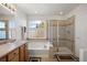 Clean bathroom featuring a soaking tub, separate shower, and neutral tiling at 2085 Cactus Bloom Ct, Castle Rock, CO 80109