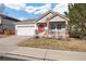 Charming home with an inviting front porch, well-maintained lawn, and a two-car garage at 2085 Cactus Bloom Ct, Castle Rock, CO 80109