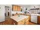 Open kitchen with wood floors, a central island, and views to the living room, ideal for entertaining at 2085 Cactus Bloom Ct, Castle Rock, CO 80109
