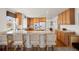 Bright kitchen with wood cabinets, bar seating, and modern appliances at 2085 Cactus Bloom Ct, Castle Rock, CO 80109