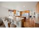 Open-concept kitchen featuring an island with seating, ample counter space, and modern appliances at 2085 Cactus Bloom Ct, Castle Rock, CO 80109