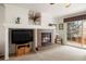 Inviting living room with a fireplace, TV, and access to the patio at 2085 Cactus Bloom Ct, Castle Rock, CO 80109