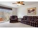 Comfortable living room featuring large glass doors to a deck and plush seating at 2085 Cactus Bloom Ct, Castle Rock, CO 80109
