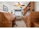 Office with custom built-in cabinets and desk with roll top and neutral carpet at 2085 Cactus Bloom Ct, Castle Rock, CO 80109