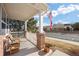 Inviting front porch featuring brick columns, a bench, and an American flag for a warm welcome at 2085 Cactus Bloom Ct, Castle Rock, CO 80109