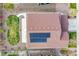 Aerial view of the property showing a well-maintained roof with solar panels and a landscaped backyard at 7763 S Elk St, Aurora, CO 80016