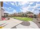 Backyard features a concrete patio, small grass area, rock beds, and perimeter fence at 7763 S Elk St, Aurora, CO 80016