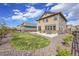 Backyard view of large lot featuring a patio, grass area, and landscaped borders at 7763 S Elk St, Aurora, CO 80016