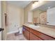 Bathroom with single sink vanity, framed mirror, tile flooring, and shower with curtain at 7763 S Elk St, Aurora, CO 80016