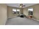 Bedroom with bright natural light, neutral walls, and plush carpeting at 7763 S Elk St, Aurora, CO 80016