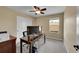 Bedroom/office space with closet and window, neutral carpet and ceiling fan at 7763 S Elk St, Aurora, CO 80016