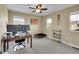 Bedroom/office space with carpet, ceiling fan, and window overlooking neighborhood at 7763 S Elk St, Aurora, CO 80016