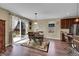 Bright dining area with wood floors, slider to the back yard, and stylish decor at 7763 S Elk St, Aurora, CO 80016