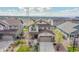 Charming two-story home featuring a well-manicured front yard and an attached two-car garage at 7763 S Elk St, Aurora, CO 80016