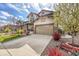 Beautiful home featuring a manicured lawn, a welcoming porch, and a convenient two-car garage at 7763 S Elk St, Aurora, CO 80016
