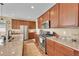 Well-equipped kitchen with stainless steel appliances and granite countertops at 7763 S Elk St, Aurora, CO 80016