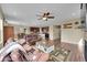 Open-concept living room featuring hardwood floors, a ceiling fan, and plenty of natural light at 7763 S Elk St, Aurora, CO 80016