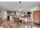 Open concept living area featuring a fireplace, wood floors, and dining space at 7763 S Elk St, Aurora, CO 80016