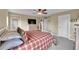 Comfortable bedroom with a ceiling fan, neutral walls, and ample closet space at 7763 S Elk St, Aurora, CO 80016