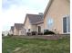 Manicured backyard with stone wall, air conditioning units, and back patio at 1343 Villa Grv, Monument, CO 80132