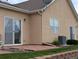 Back patio with sliding glass door and central air unit at 1343 Villa Grv, Monument, CO 80132