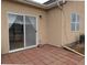 Outdoor space featuring a brick patio, sliding glass door, and a bush at 1343 Villa Grv, Monument, CO 80132