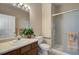 Bright bathroom with a glass shower and wooden cabinets at 1343 Villa Grv, Monument, CO 80132