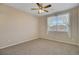 Bedroom with neutral carpet, ceiling fan, and window at 1343 Villa Grv, Monument, CO 80132
