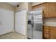 Kitchen featuring stainless steel refrigerator and matching oak cabinets at 1343 Villa Grv, Monument, CO 80132