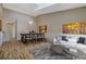 Bright living room featuring hardwood floors, dining area, and stylish contemporary furnishings at 1343 Villa Grv, Monument, CO 80132