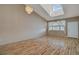Bright living room with vaulted ceiling, wood floors, and a modern chandelier at 1343 Villa Grv, Monument, CO 80132