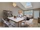 Bright living room with vaulted ceiling, skylight, wood floors, and modern decor at 1343 Villa Grv, Monument, CO 80132