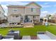A spacious backyard featuring a deck, green lawn, outdoor furniture and a play set at 2468 Candleglow St, Castle Rock, CO 80109
