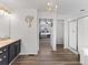 Bright bathroom with a wood-look floor, an open doorway to a bedroom, and a walk-in shower at 2468 Candleglow St, Castle Rock, CO 80109