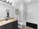 A clean bathroom featuring a bath tub/shower, vanity with sink, toilet, and modern fixtures at 2468 Candleglow St, Castle Rock, CO 80109