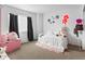 A relaxing bedroom with black curtains, wall decor, and a comfortable bed with white sheets at 2468 Candleglow St, Castle Rock, CO 80109