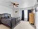A cozy bedroom featuring a ceiling fan, and a comfortable bed with stylish bedding at 2468 Candleglow St, Castle Rock, CO 80109