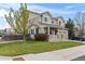 Charming two-story home with a covered front porch, landscaped yard, and an attached two-car garage at 2468 Candleglow St, Castle Rock, CO 80109