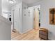 Hallway with hardwood floors, closet, and access to other rooms through a sliding barn door at 2468 Candleglow St, Castle Rock, CO 80109