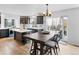 Spacious kitchen with an island, dark cabinets, and an adjacent dining area with backyard access at 2468 Candleglow St, Castle Rock, CO 80109