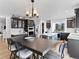 Modern kitchen with dark cabinetry, stainless steel appliances, an island, and a spacious dining area at 2468 Candleglow St, Castle Rock, CO 80109