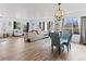 Bright living room with hardwood floors, large windows, stylish furniture, and decorative chandelier at 2468 Candleglow St, Castle Rock, CO 80109
