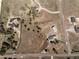 Aerial shot reveals a property's layout with driveway, landscaping, and surrounding neighborhood at 5917 Black Forest Dr, Elizabeth, CO 80107