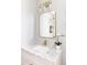 A modern bathroom featuring granite countertops, brass fixtures, and a framed mirror at 5917 Black Forest Dr, Elizabeth, CO 80107